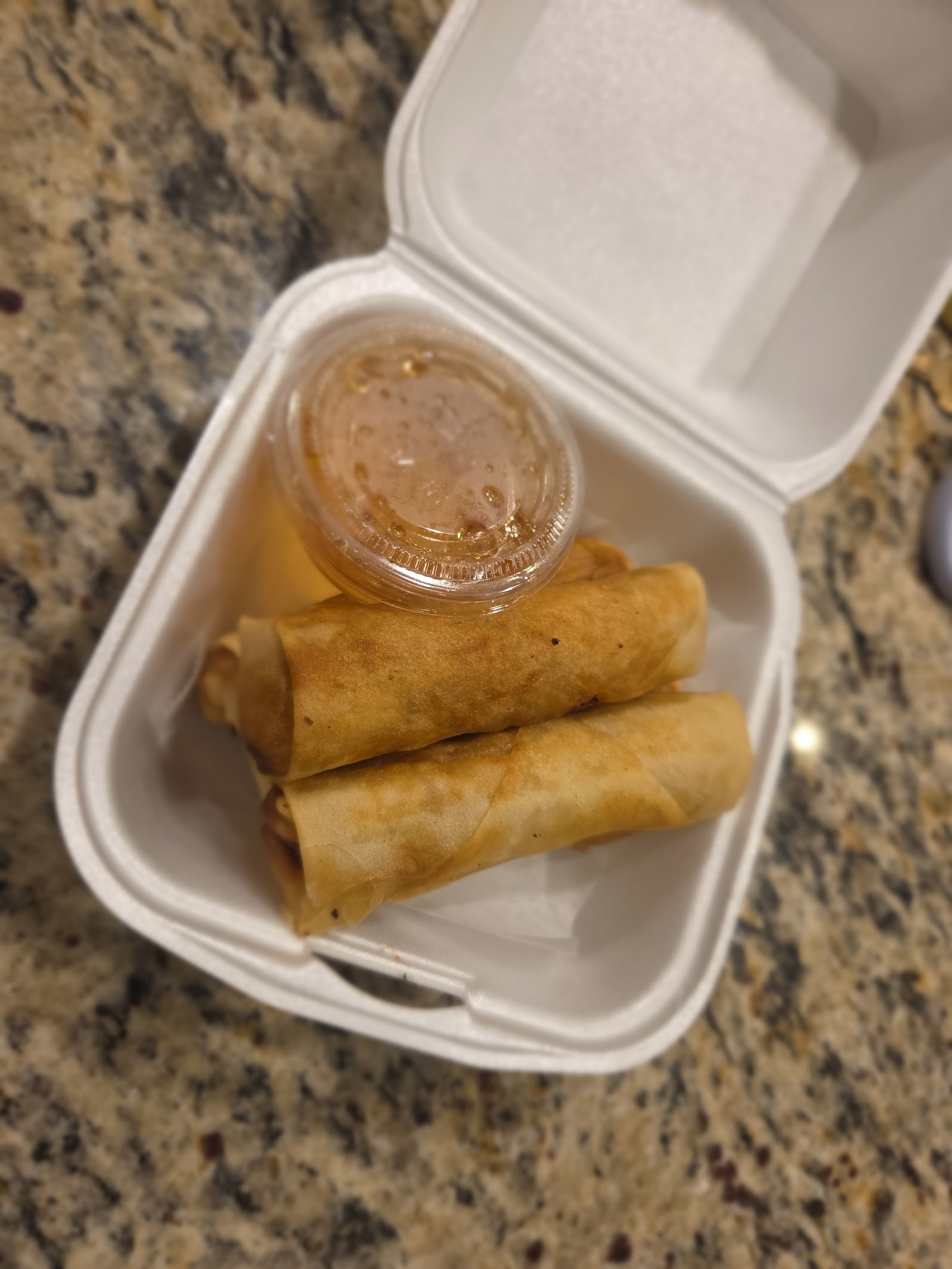 Crispy fried egg rolls with honey dipping sauce